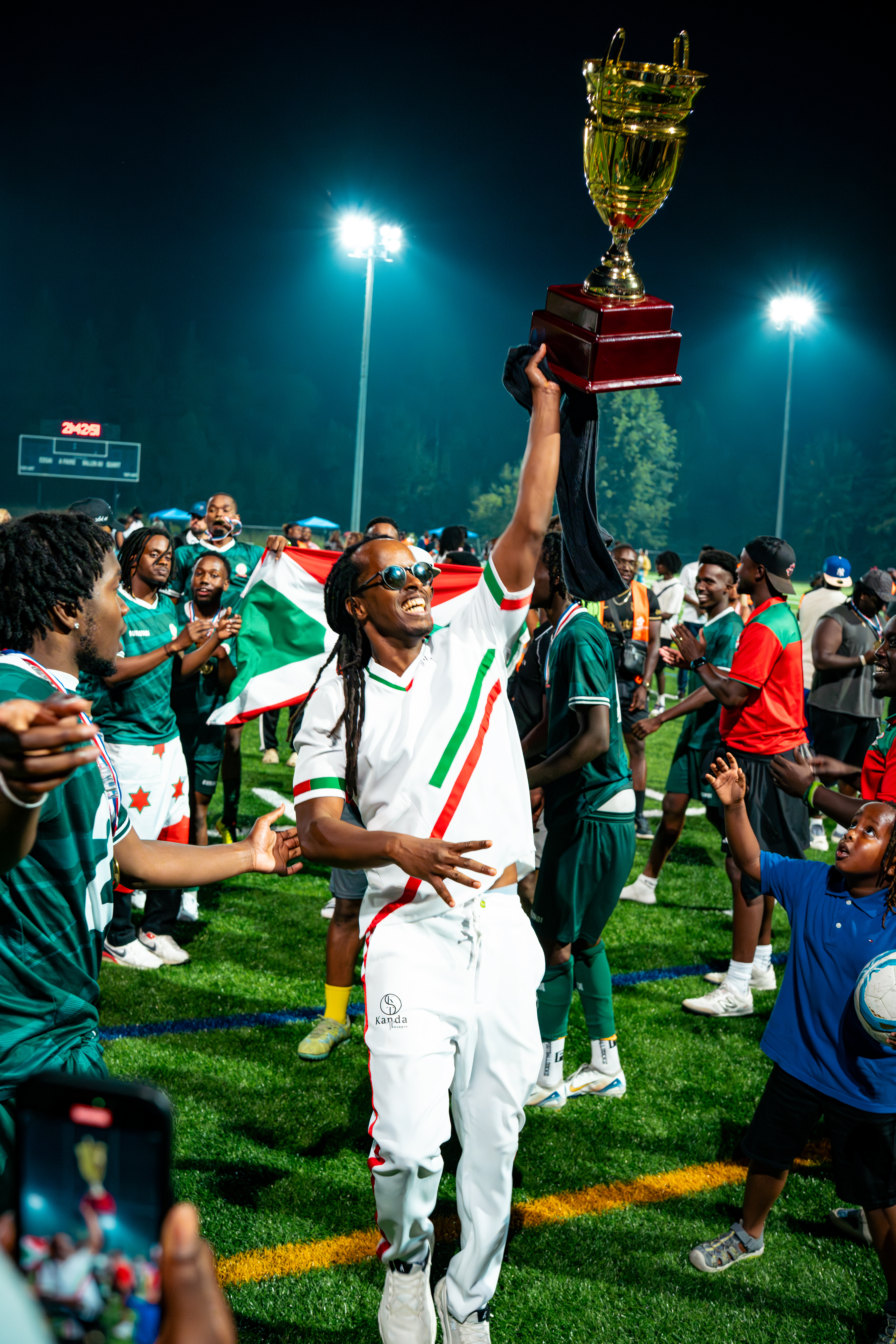 Members of Les Hirondelles (Burundi) soccer team celebrating their CANGATO championship victory.